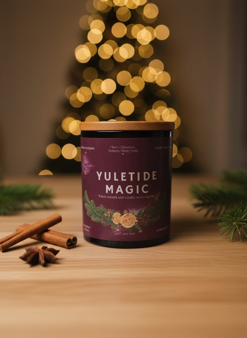 Yuletide Magic luxury Christmas candle styled with cinnamon and evergreen beside a Christmas tree