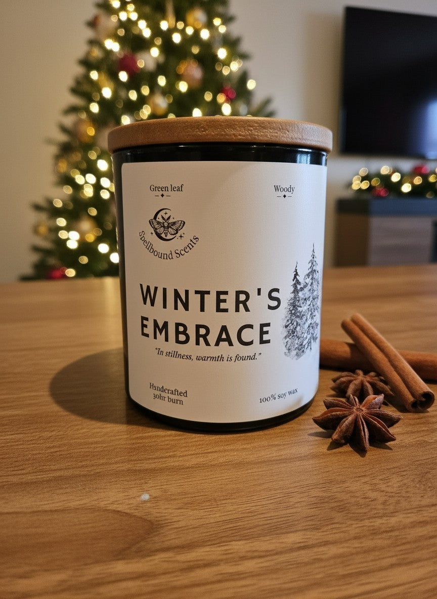 Winter’s Embrace luxury Christmas candle styled with cinnamon beside a decorated Christmas tree
