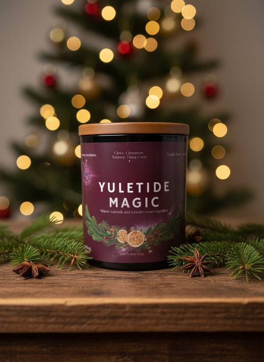 Yuletide Magic Christmas candle by Spellbound Scents styled with evergreen branches and festive spices